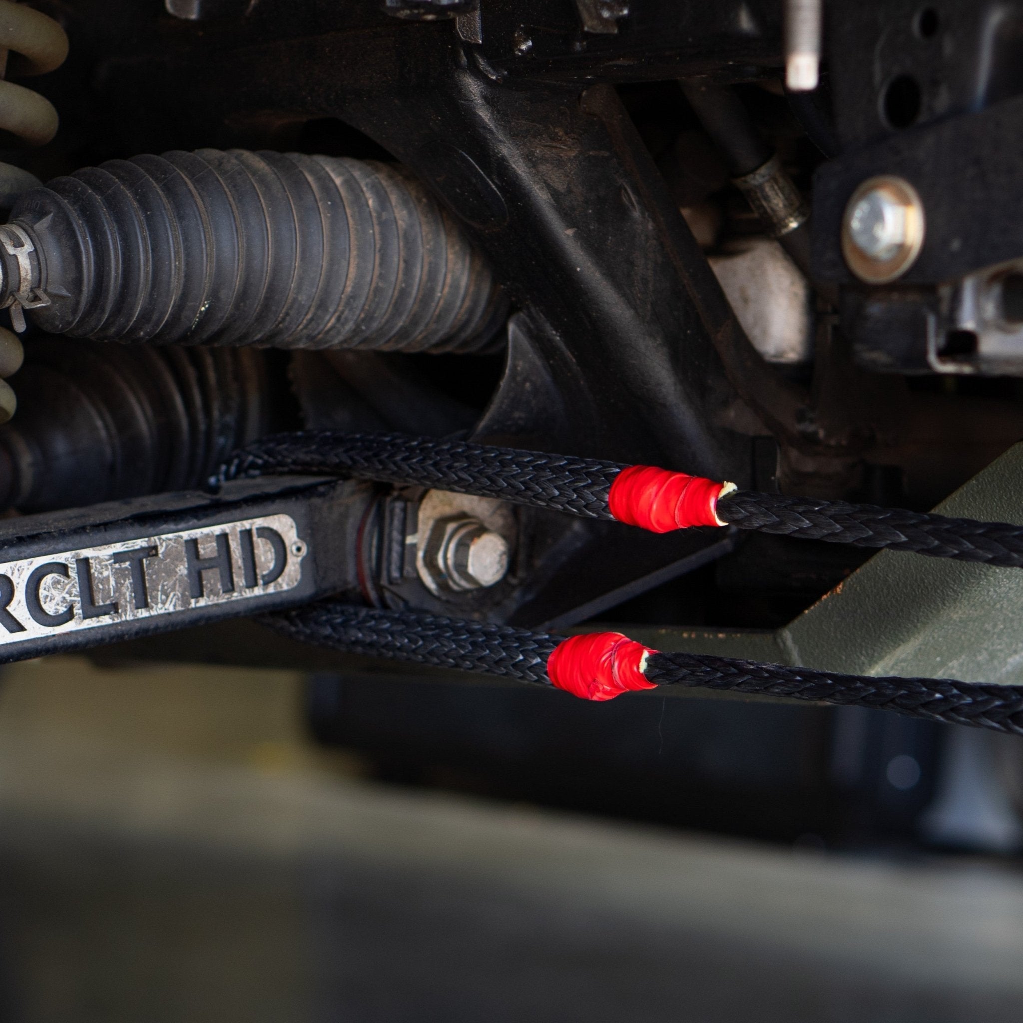 Hero Bridle around a control arm with the cover slid back, showing the protected center