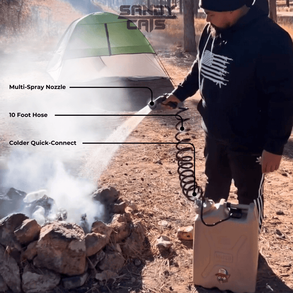 Person using TrailWash system with multi-spray nozzle, 10-foot coiled hose, and Colder quick-connect to extinguish a campfire