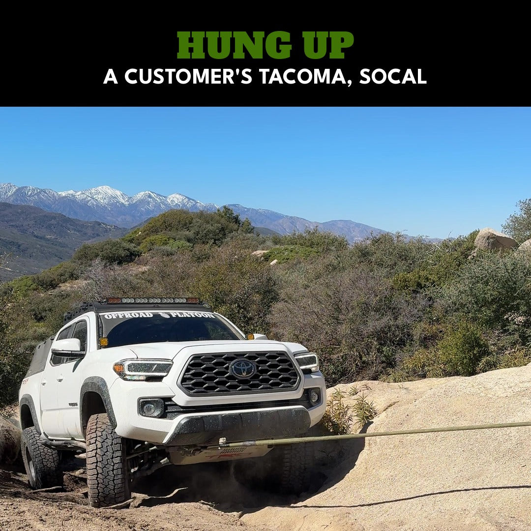 A customer's Tacoma hung up on a sand ledge on a SoCal trail, being pulled up on a Kinetic-X kinetic rope